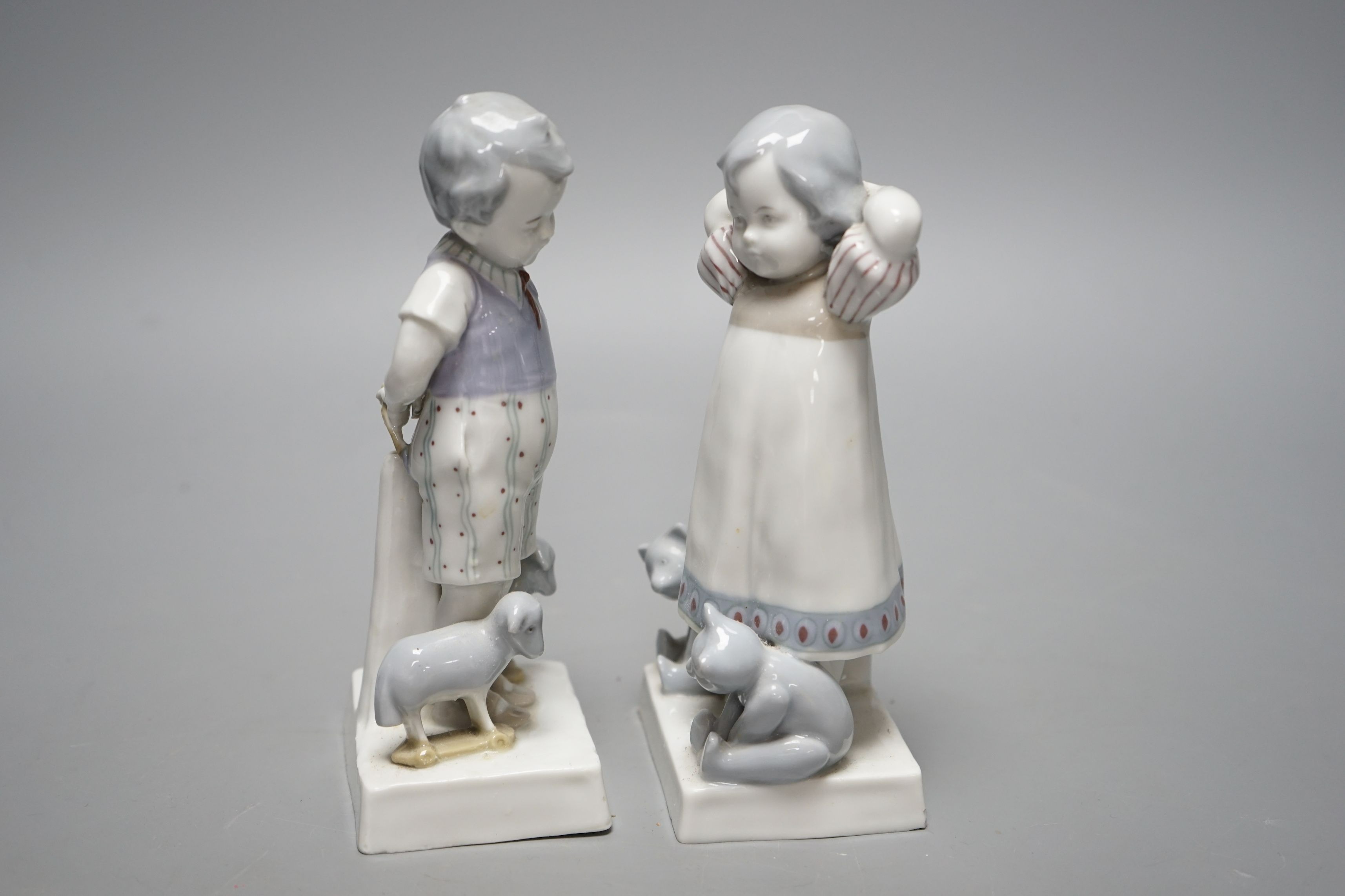 Teddy bear & Steiff collector’s interest - a pair of 1920s German Goebel porcelain figures of a girl and two teddy bears and a boy with two pull-along sheep on wheels, 17cms high